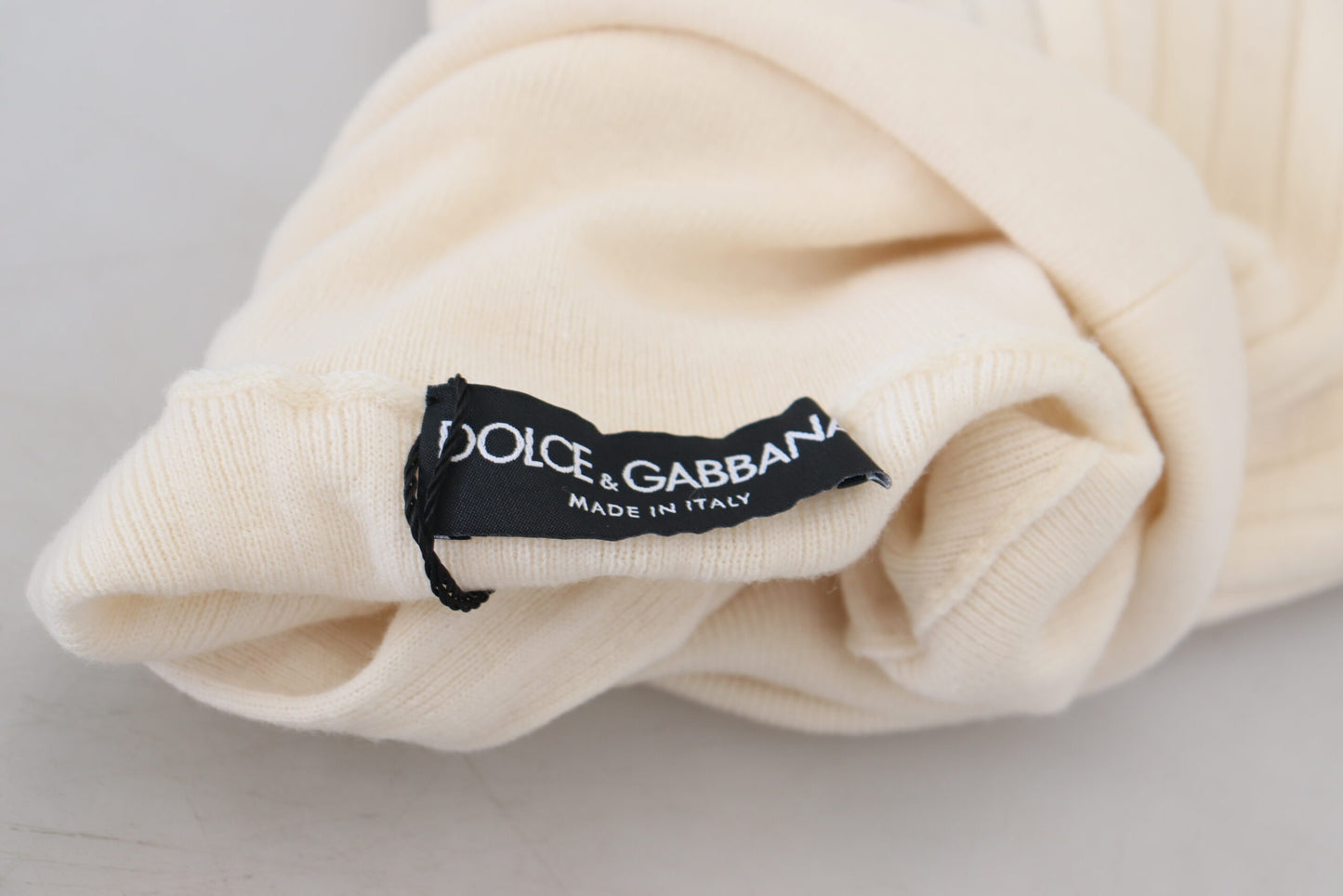 Dolce & Gabbana Elfenbeinfarbener Rollkragenpullover mit ausgefranster Manschette